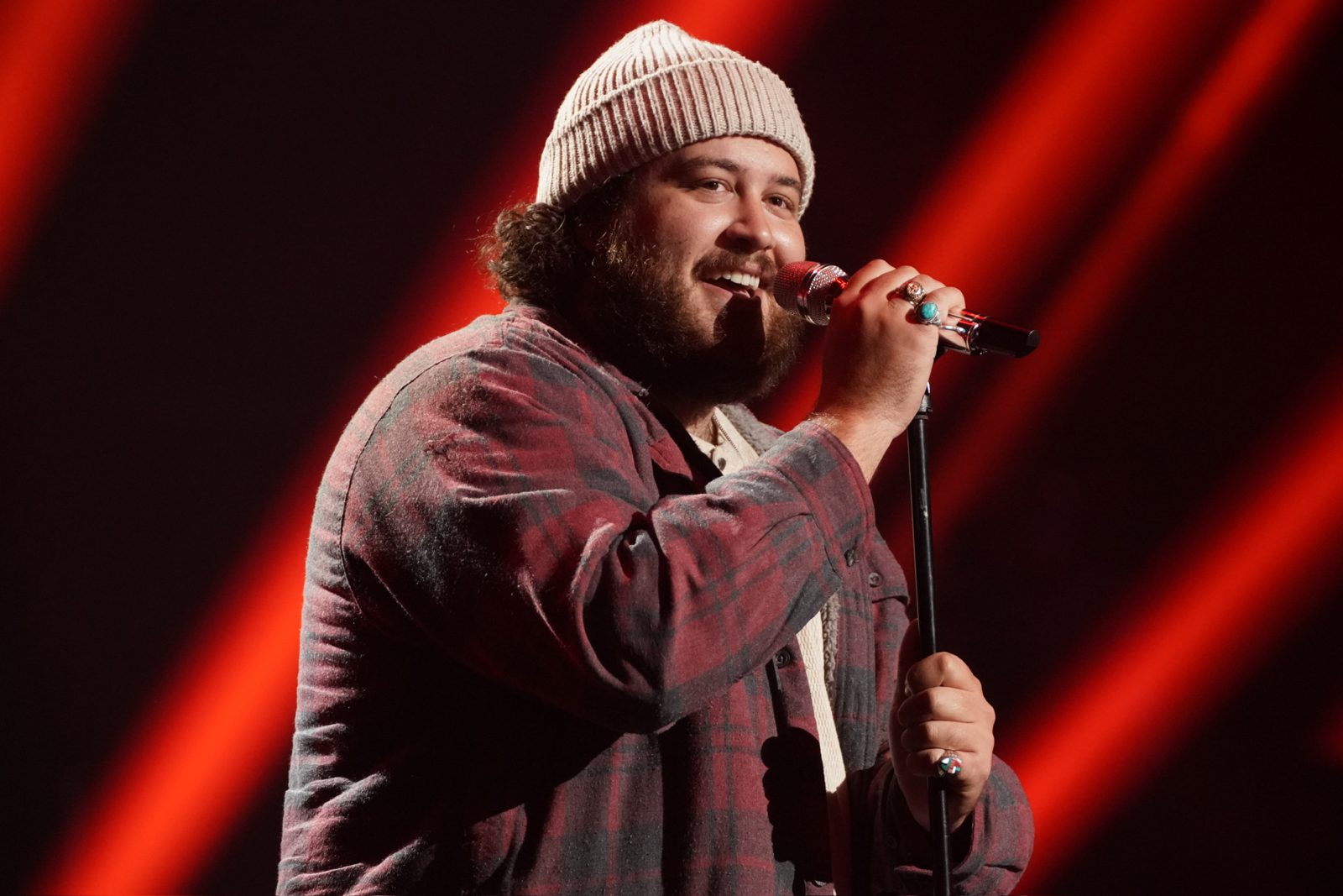 Graham DeFranco singing into a microphone under red stage lights — Instagram post by @grahamdefranco