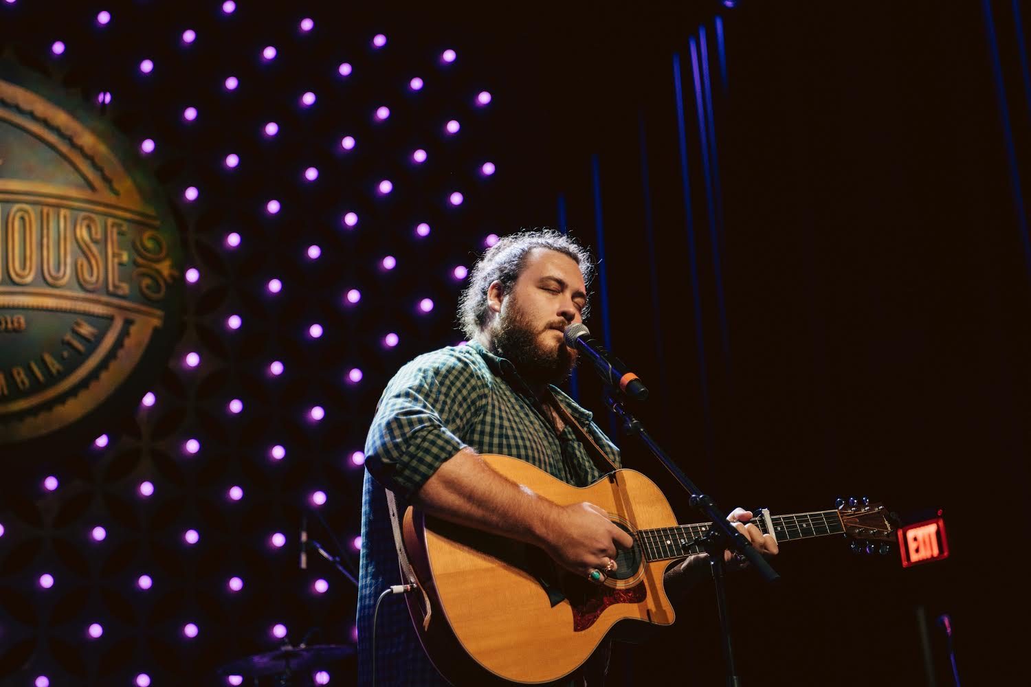 Graham DeFranco playing acoustic guitar on a lit stage — Instagram post by @grahamdefranco