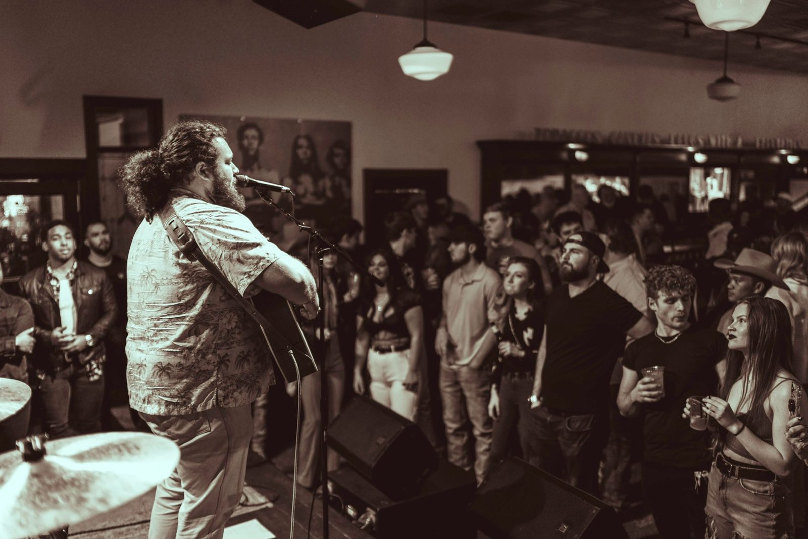 Graham DeFranco singing to a packed bar crowd, black and white — Instagram post by @grahamdefranco